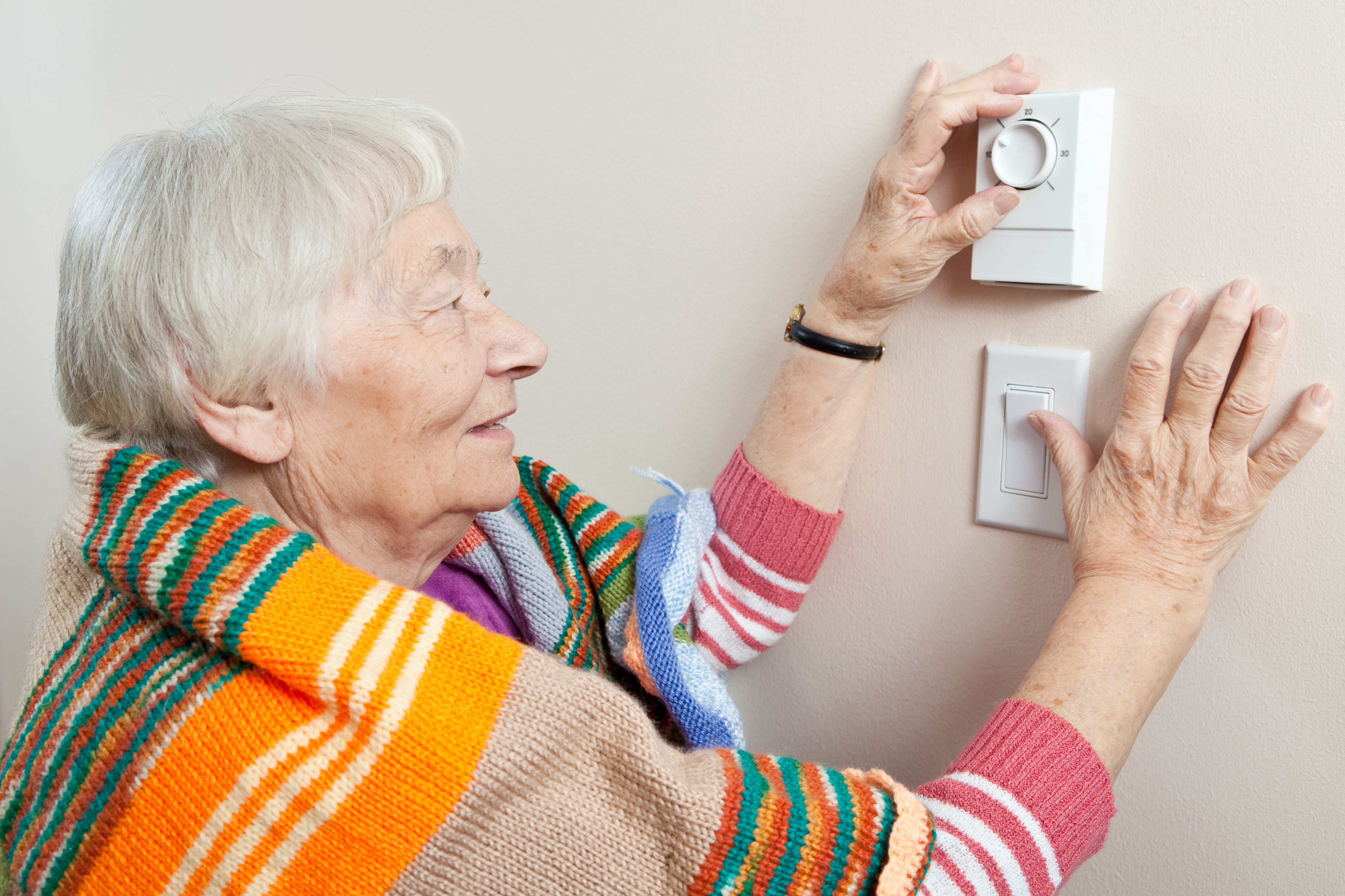 Ols Woman at Thermostat